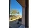 Window view of a xeriscaped backyard featuring desert landscaping, shrubs, and seating area at 2764 Leys Burnett Ave, Henderson, NV 89044