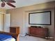 Bedroom with large television screen and dark wood dresser, with a door leading to another room at 2764 Leys Burnett Ave, Henderson, NV 89044