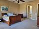 Spacious carpeted main bedroom with ceiling fan, wood furniture, and ensuite bathroom with soaking tub at 2764 Leys Burnett Ave, Henderson, NV 89044