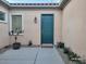 Front door and courtyard featuring desert landscaping, and exterior sconce lighting at 2764 Leys Burnett Ave, Henderson, NV 89044