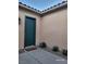 Front door and courtyard featuring desert landscaping, and exterior sconce lighting at 2764 Leys Burnett Ave, Henderson, NV 89044