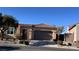 Single level home featuring a tile roof, desert landscaping, and attached two car garage at 2764 Leys Burnett Ave, Henderson, NV 89044