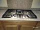 Close-up of a professional-grade gas cooktop set into the countertop at 2764 Leys Burnett Ave, Henderson, NV 89044