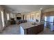 Open concept kitchen with large island and stainless steel appliances flows into the living room at 2764 Leys Burnett Ave, Henderson, NV 89044