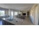 Open living area featuring tile floors, kitchen island, fireplace, and stainless steel appliances at 2764 Leys Burnett Ave, Henderson, NV 89044