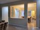 Open floor plan view of a dining room and living room with cream walls and tile floors at 2764 Leys Burnett Ave, Henderson, NV 89044