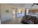 Open-concept living room with tile flooring, a large couch, and views into the dining room at 2764 Leys Burnett Ave, Henderson, NV 89044