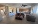 Open-concept living room flowing into kitchen, featuring tile floors and neutral color palette at 2764 Leys Burnett Ave, Henderson, NV 89044