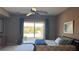 Main bedroom with ceiling fan and backyard view through sliding glass doors at 2764 Leys Burnett Ave, Henderson, NV 89044