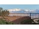 Stunning mountain view behind a decorative tile roof and wrought iron fence at 2764 Leys Burnett Ave, Henderson, NV 89044