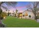 Spacious backyard featuring mature trees, a green lawn, and a covered patio area at 2785 Soft Horizon Way, Las Vegas, NV 89135