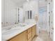 Well-lit bathroom with double sinks, white cabinets, and a glass-enclosed shower at 2785 Soft Horizon Way, Las Vegas, NV 89135