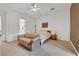 Bright bedroom featuring a ceiling fan, tiled floors, and access to the ensuite bathroom at 2785 Soft Horizon Way, Las Vegas, NV 89135