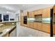 Well-equipped kitchen featuring granite countertops, wooden cabinetry, and modern appliances at 2785 Soft Horizon Way, Las Vegas, NV 89135