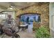 Covered patio featuring stone archways, hanging chair and dining set at 2785 Soft Horizon Way, Las Vegas, NV 89135