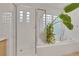 Modern shower features glass doors, neutral tile, and a soaking tub with a plant at 2785 Soft Horizon Way, Las Vegas, NV 89135