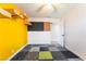 Interesting bedroom with a geometric patterned carpet, yellow wall and wooden wall fixtures at 308 Fox Cir, Las Vegas, NV 89107