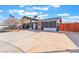 Updated home with a long driveway and partial privacy fence adding curb appeal at 308 Fox Cir, Las Vegas, NV 89107