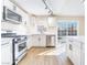 Contemporary kitchen with stainless appliances, white cabinetry, and sliding glass doors to the pool at 308 Fox Cir, Las Vegas, NV 89107