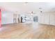 Expansive living room featuring wood-look floors, opening to a kitchen area with stainless appliances at 308 Fox Cir, Las Vegas, NV 89107