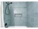 Shower boasts sleek, modern fixtures and blue tiling with a convenient inset shelf at 308 Fox Cir, Las Vegas, NV 89107