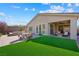 Backyard with artificial turf, dining set, lounge chairs and mountain views at 32 Via Del Fiume, Henderson, NV 89011