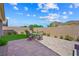 Backyard with patio, turf, dining set and mountain views at 32 Via Del Fiume, Henderson, NV 89011