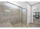 Modern bathroom features a glass-enclosed shower with gray tile and a built-in bench at 32 Via Del Fiume, Henderson, NV 89011