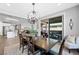 Open-concept dining area featuring a chandelier, sliding glass doors and modern decor at 32 Via Del Fiume, Henderson, NV 89011