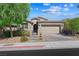 Charming single-story home with a two-car garage, neutral colors and a paved driveway and walkway at 32 Via Del Fiume, Henderson, NV 89011