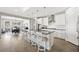 Open-concept kitchen with island seating, stainless steel appliances, and a seamless connection to the dining area at 32 Via Del Fiume, Henderson, NV 89011