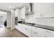 Modern kitchen with white cabinets, stainless steel appliances, and a gray countertop at 32 Via Del Fiume, Henderson, NV 89011