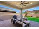 An outdoor patio includes a seating area, grill, stone fire pit, and view of the desert landscape at 32 Via Del Fiume, Henderson, NV 89011