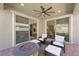 Covered patio featuring a ceiling fan, fire pit, and comfortable seating for outdoor relaxation at 32 Via Del Fiume, Henderson, NV 89011