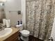 Well-maintained bathroom featuring a patterned shower curtain, toilet, and functional sink area at 3318 N Decatur Blvd # 1043, Las Vegas, NV 89130