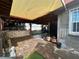 Covered backyard patio with brick floors, an outdoor kitchen, and space for entertaining at 3601 Chevy Chase Ave, Las Vegas, NV 89110