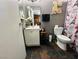 Bathroom with a white vanity, dark stone floors, and Eiffel tower shower curtain at 3601 Chevy Chase Ave, Las Vegas, NV 89110