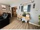 Inviting living room with wood-style flooring, homey decorations and a view into the dining area at 3601 Chevy Chase Ave, Las Vegas, NV 89110