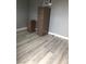 Clean, modern room with laminate flooring and a file cabinet in the corner at 3601 Chevy Chase Ave, Las Vegas, NV 89110