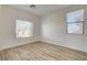 Bright bedroom with hardwood floors and a large window allowing natural light to illuminate the space at 3932 Maldive Isle Ct, Las Vegas, NV 89129