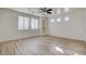 Large bright bedroom featuring modern ceiling fan, wood floors, and recessed shelving at 3932 Maldive Isle Ct, Las Vegas, NV 89129