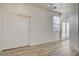 Light-filled bedroom with wood floors, closet, window, and doors leading to outdoor space at 3932 Maldive Isle Ct, Las Vegas, NV 89129