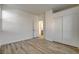 Bedroom featuring hardwood floors, closet with sliding doors, and an open doorway to the attached bathroom at 3932 Maldive Isle Ct, Las Vegas, NV 89129