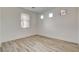 Bright bedroom with wood-look flooring and natural light from multiple windows at 3932 Maldive Isle Ct, Las Vegas, NV 89129