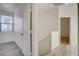 Hallway with staircase, hardwood floors, white walls, and an entrance to a bedroom at 3932 Maldive Isle Ct, Las Vegas, NV 89129