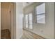 Well-lit hallway featuring hardwood floors, window, and an entrance to a room with french doors at 3932 Maldive Isle Ct, Las Vegas, NV 89129