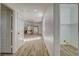 Long hallway with wood-look flooring offers seamless transitions and storage spaces at 3932 Maldive Isle Ct, Las Vegas, NV 89129