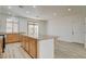 Spacious kitchen featuring a large island, wooden cabinets, and granite countertops at 3932 Maldive Isle Ct, Las Vegas, NV 89129