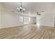 Bright, open-concept living room featuring wood-look floors and neutral paint colors at 3932 Maldive Isle Ct, Las Vegas, NV 89129