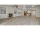 Spacious living room featuring a fireplace, an open floor plan and new wood-look floors at 3932 Maldive Isle Ct, Las Vegas, NV 89129